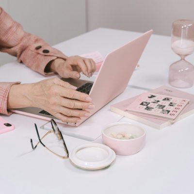 Person Using a Macbook with Pink Case